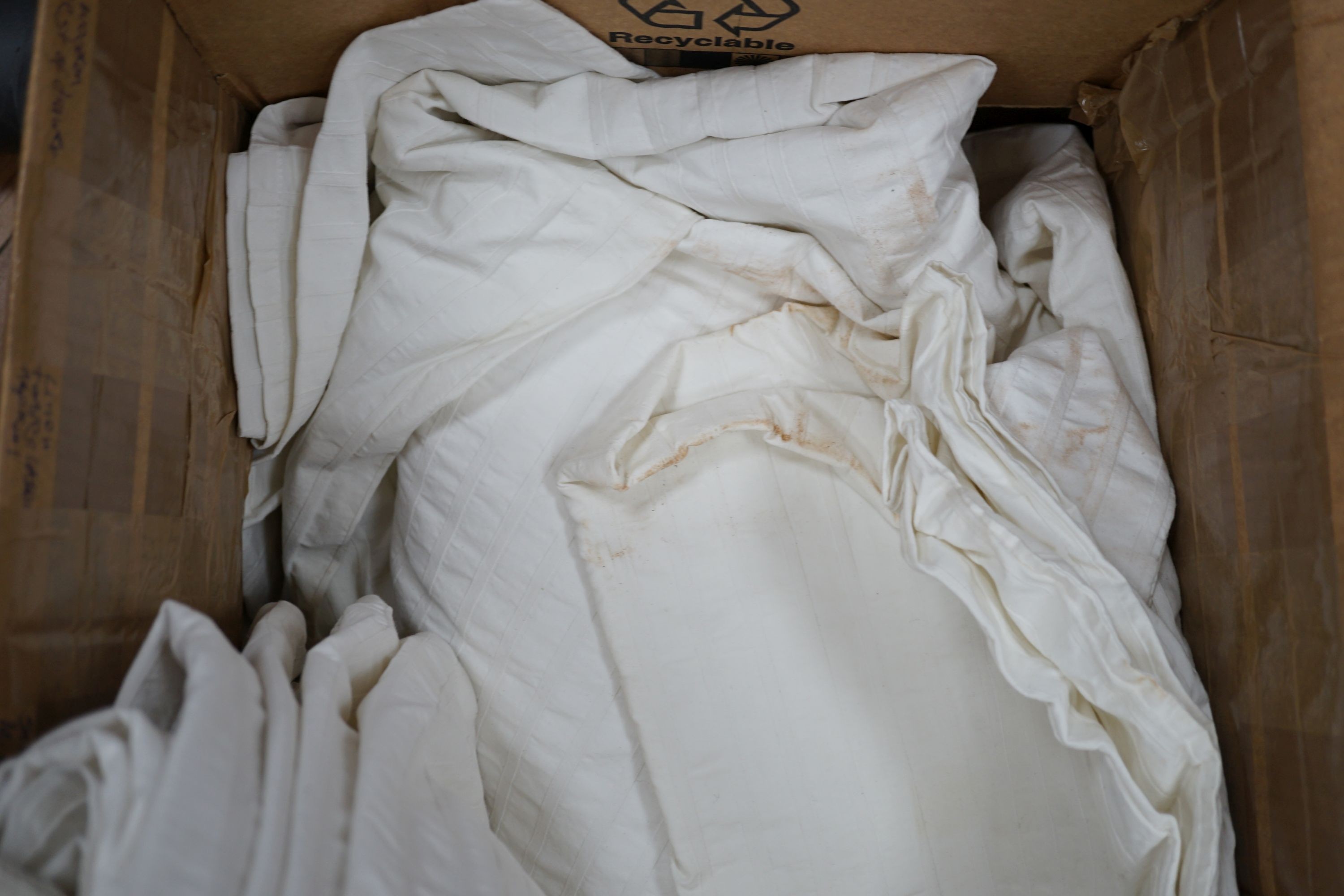 A box of mixed linen and 1950's hand embroidered cream curtain
